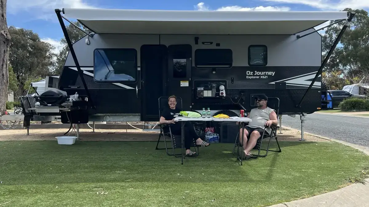 Couple relaxing in camp chairs in front of the Explorer X621
