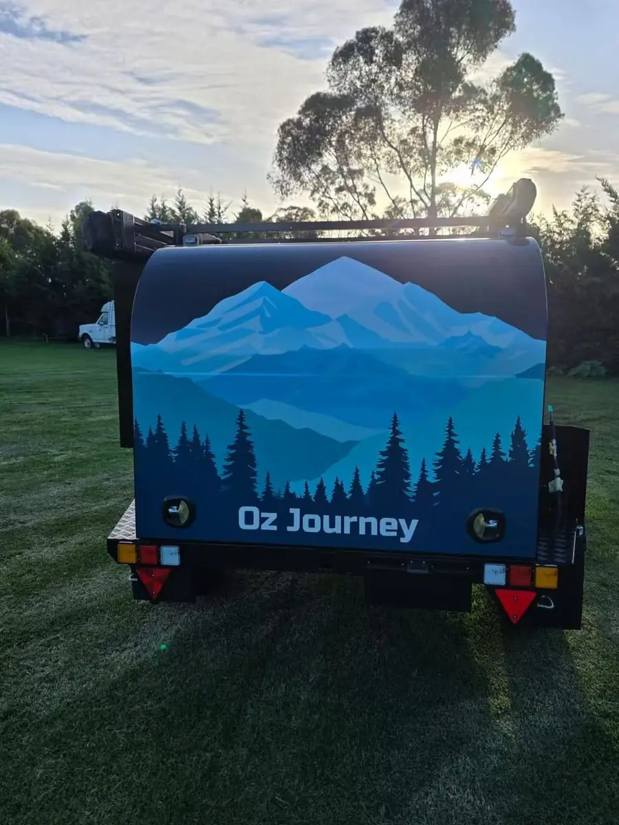 Rear of the camper with mountain artwork