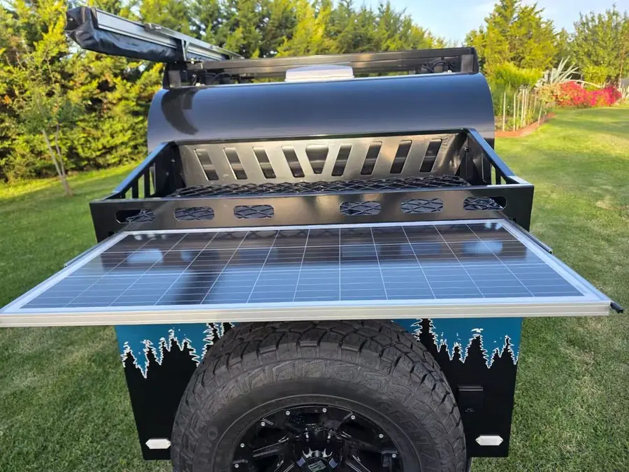 Slide-out solar panel on the front rack