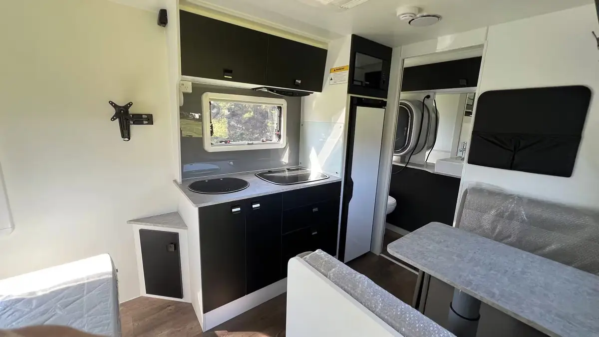 Explorer X216 kitchen with cooktop, sink, fridge and microwave